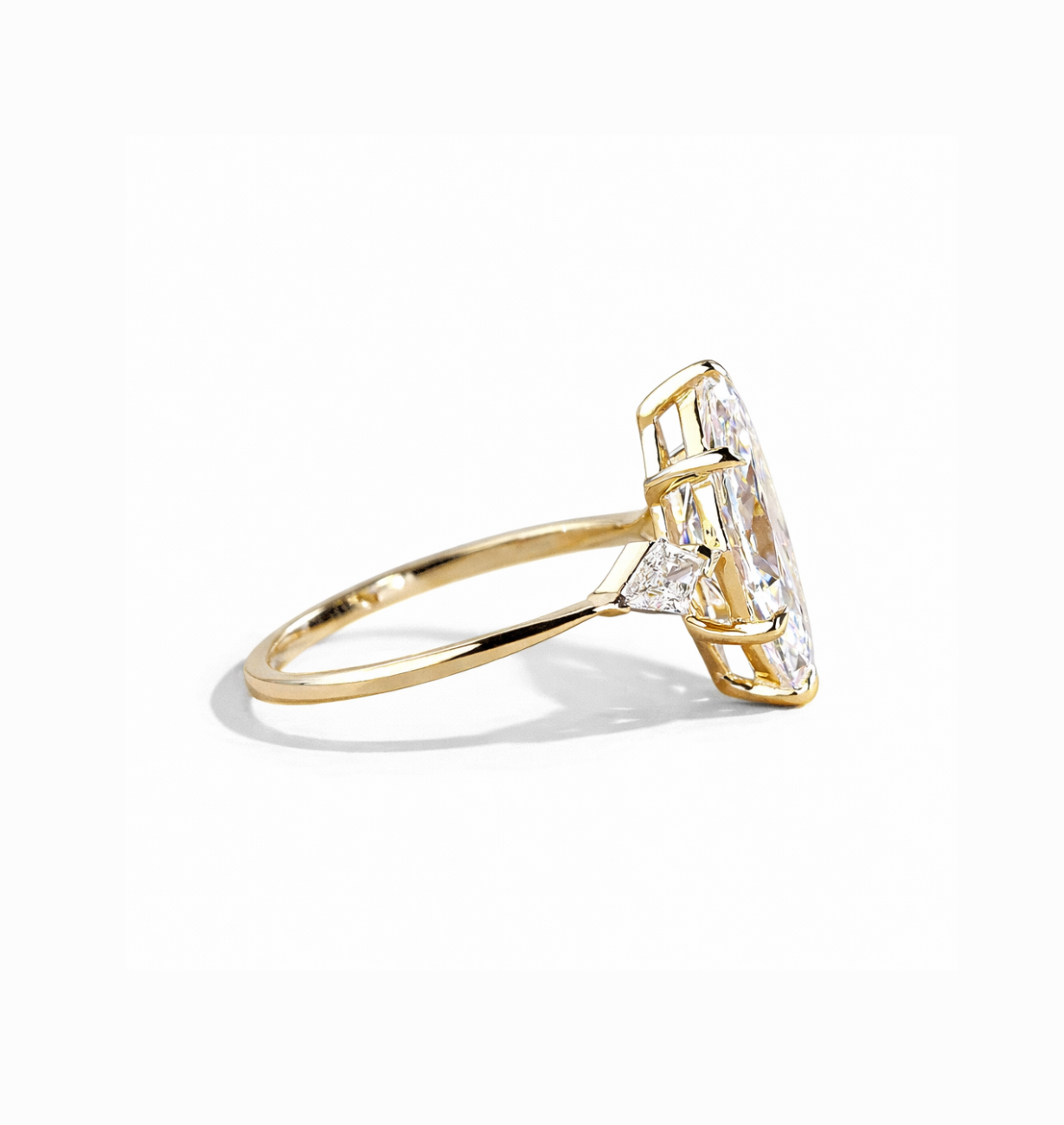 side view of marquise lab grown diamond engagement ring with kite side stones in 14k gold