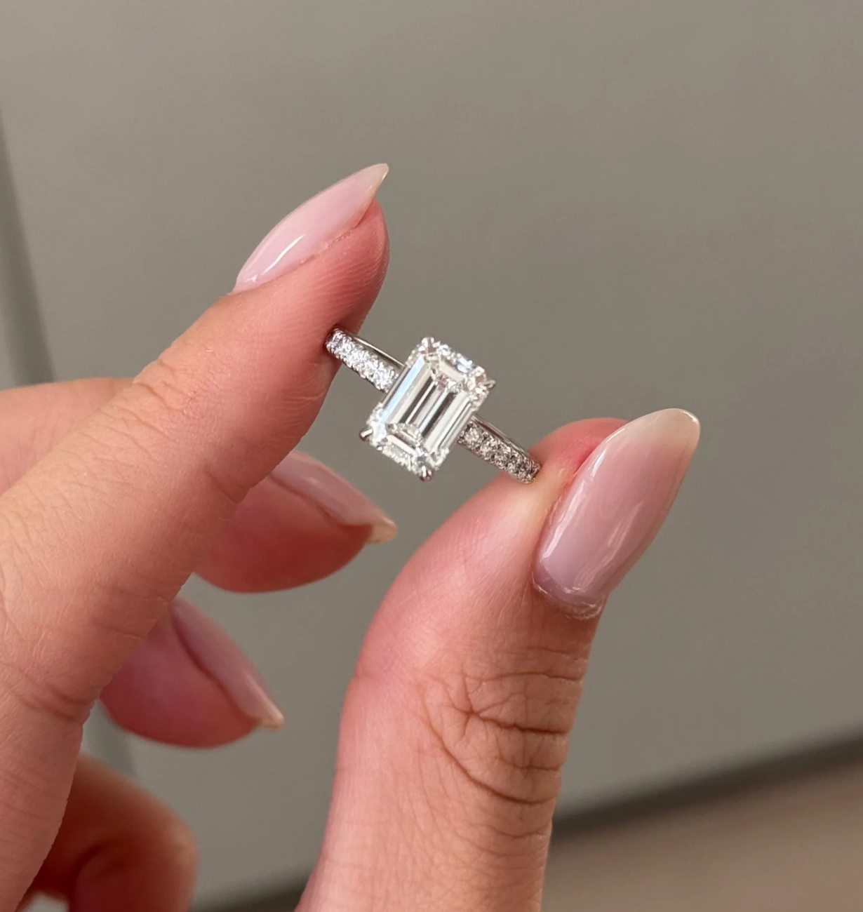 top view of emerald cut lab grown diamond engagement ring with pave band