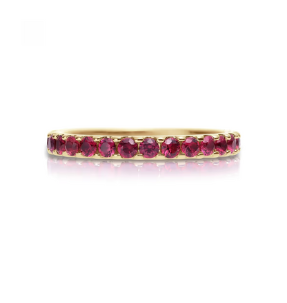 Gold ring with red gemstones on a white background