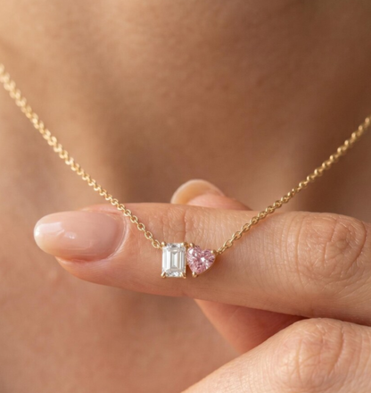 Pink heart-cut diamond paired with emerald-cut diamond on Toi et Moi Necklace