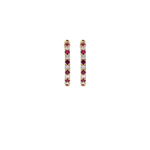Ruby Huggie Hoop Earrings with vibrant red stones.