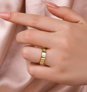 Gold ring with a diamond on a hand 