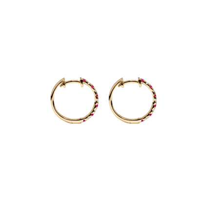Women’s ruby huggie earrings in a hoop style.