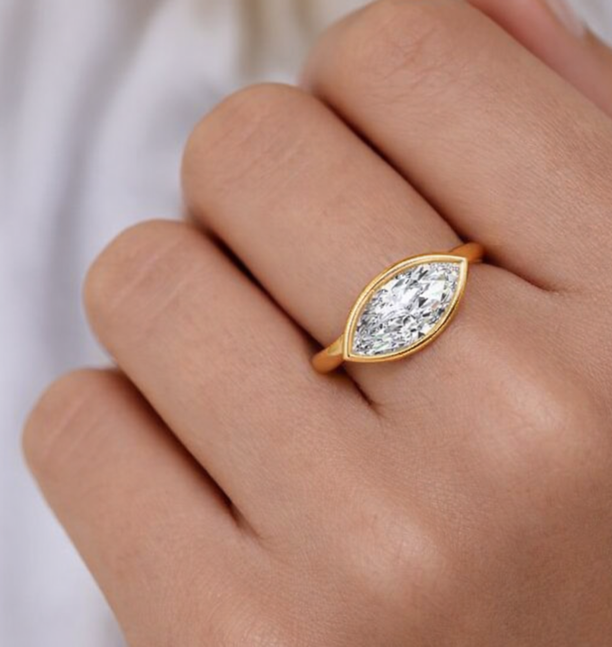 close-up of east west marquise lab grown diamond ring in 14k yellow gold