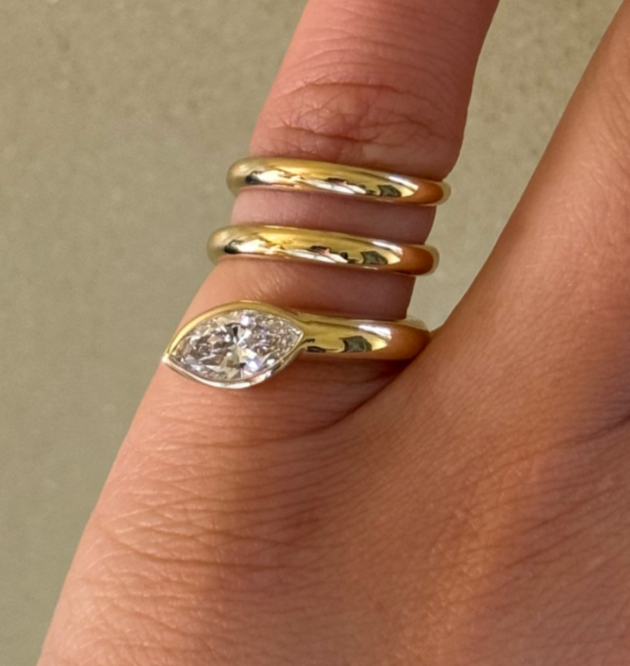 close-up of marquise lab grown diamond bezel ring in gold