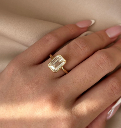 emerald cut lab grown diamond engagement ring with bezel setting in 14k yellow gold