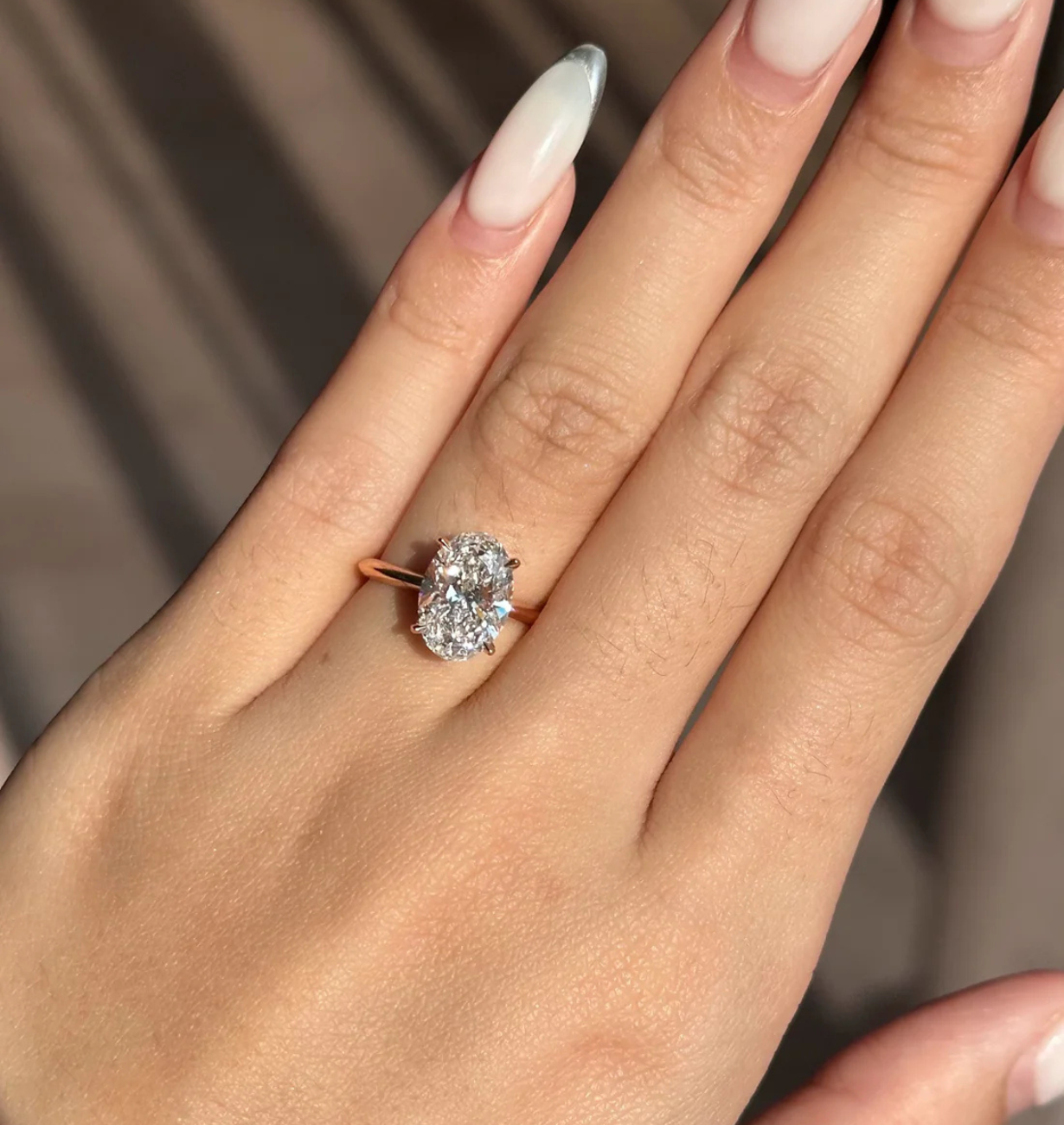 oval lab grown diamond engagement ring with bezel setting in 14k gold